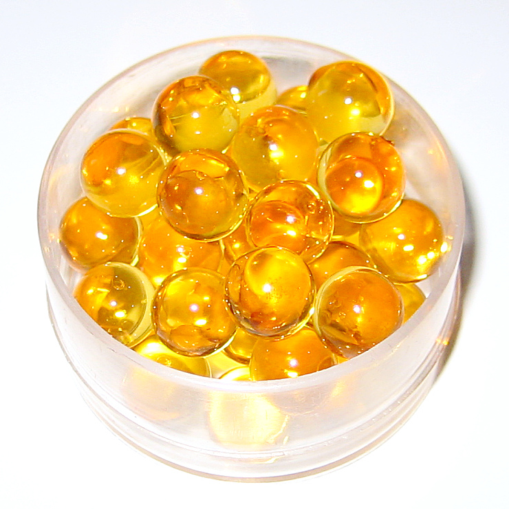 Cápsulas de suplemento de vitamina em formato de gel, cor laranja
